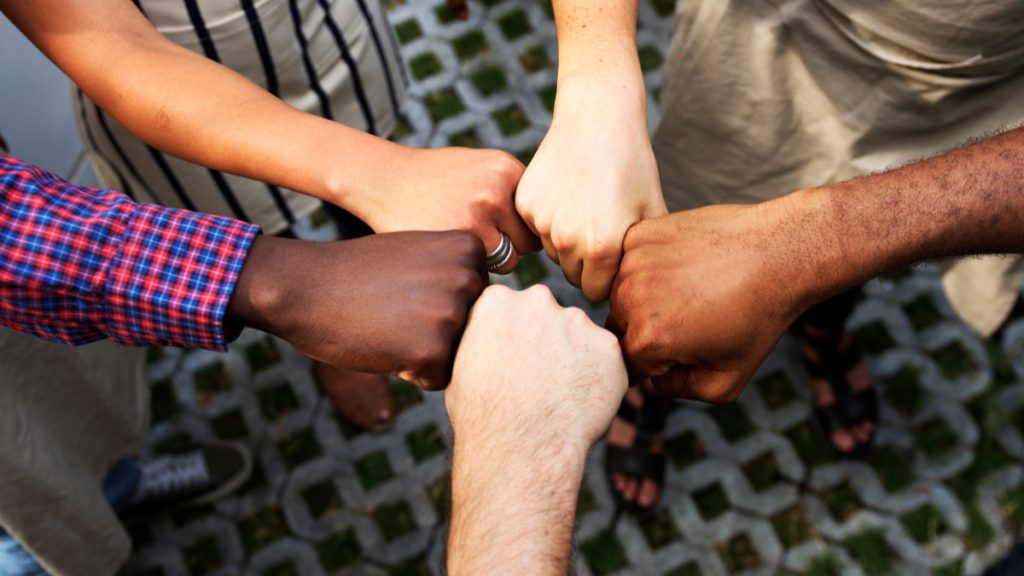 diversity hands fist bump for support and team building
